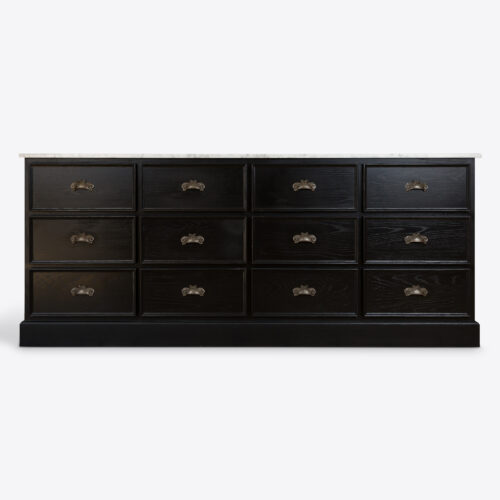 large bank of drawers in black oak with marble top