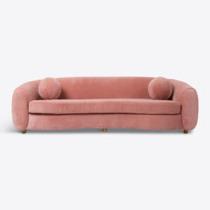 curved sofa in pink velvet with pink ball cushion