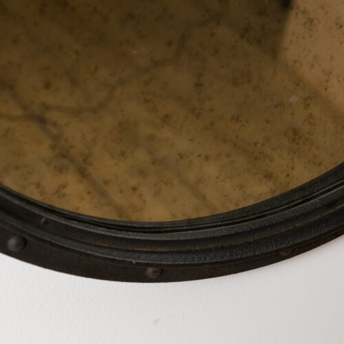 round aged glass mirror with industrial black frame
